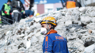 Worker looking at collapsed infrastructure in an earthquake in Turkey